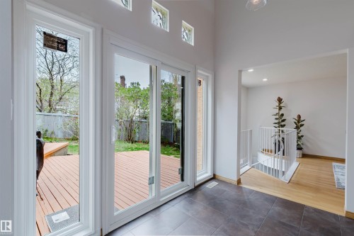 Sliding glass doors opening to an exterior wood-finish deck - 342 O'Connor Close, Edmonton, AB - Indoor Photo Showing Other Room