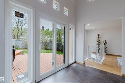 Sliding glass doors opening to an exterior wood-finish deck - 