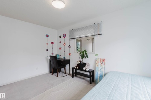 Room featuring light-toned carpet flooring, white walls, and a single window with horizontal blinds - 342 O'Connor Close, Edmonton, AB - Indoor Photo Showing Bedroom