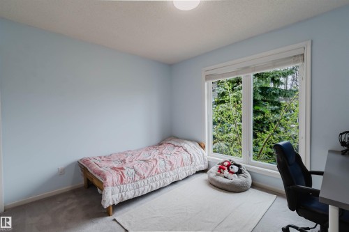 Room featuring a large window, light blue painted walls, and carpet flooring - 342 O'Connor Close, Edmonton, AB - Indoor Photo Showing Bedroom