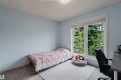 Room featuring a large window, light blue painted walls, and carpet flooring - 