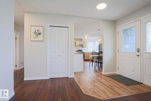 Entryway featuring a white paneled front door with leaded glass, recessed ceiling lighting, a bi-fold closet door, and wood-finish flooring - 9523 151 Street, Edmonton, AB - Indoor Photo Showing Other Room