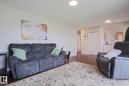 Spacious living area featuring wood-finish flooring, recessed lighting, and a neutral color palette - 9523 151 Street, Edmonton, AB - Indoor Photo Showing Living Room