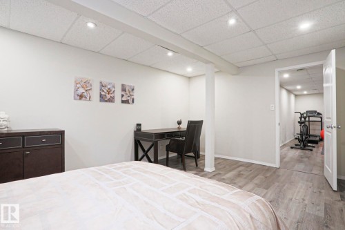 Finished lower level featuring recessed lighting, light gray walls, wood-finish flooring, and an open doorway to an additional room - 9523 151 Street, Edmonton, AB - Indoor Photo Showing Bedroom