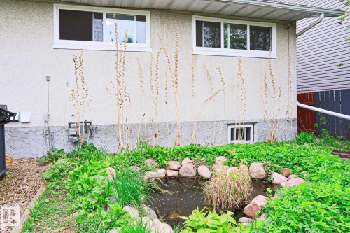 Rock-lined pond feature surrounded by established green foliage - 9523 151 Street, Edmonton, AB - Outdoor