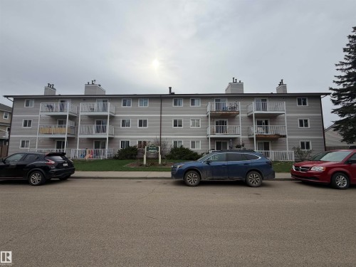 Multi-story apartment building featuring light gray siding and white trim - 205 10136 160 Street, Edmonton, AB - Outdoor With Facade