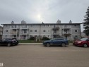 Multi-story apartment building featuring light gray siding and white trim - 205 10136 160 Street, Edmonton, AB  - Outdoor With Facade 