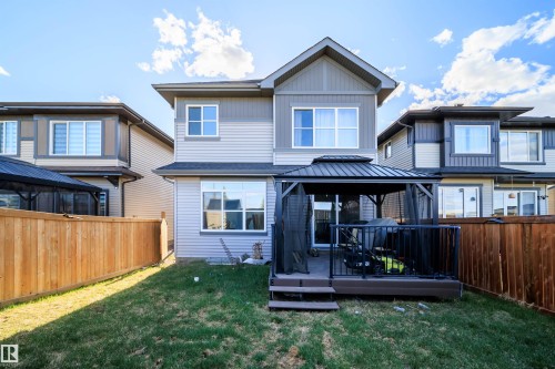 Rear exterior of a two-story residence featuring light gray siding with dark gray vertical accents - 9651 229 Street, Edmonton, AB - Outdoor