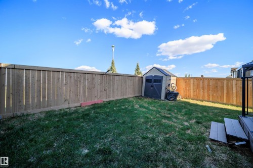 Private backyard featuring a plastic shed, wood fencing, and a small deck with steps - 9651 229 Street, Edmonton, AB - Outdoor