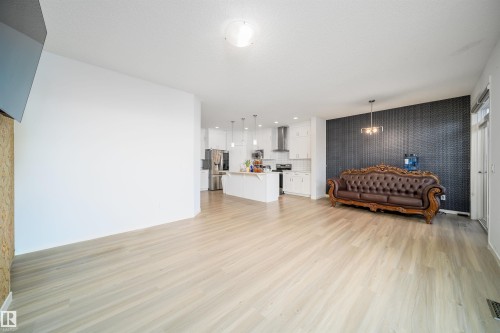 Open-concept living space with light wood-finish flooring - 9651 229 Street, Edmonton, AB - Indoor