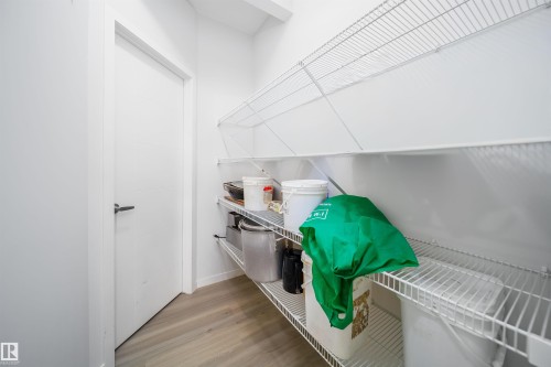 Built-in wire shelving units provide extensive storage capacity within this organized space - 9651 229 Street, Edmonton, AB - Indoor