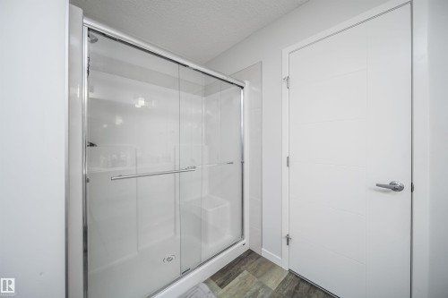 Modern shower enclosure with sliding glass door and chrome hardware - 9651 229 Street, Edmonton, AB - Indoor Photo Showing Bathroom