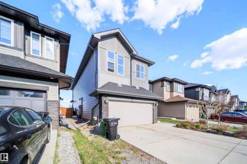 Contemporary two-story residence featuring light gray siding and dark grey stone accents - 9651 229 Street, Edmonton, AB - Outdoor
