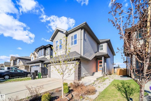Modern two-story home featuring a grey siding exterior with dark stone accents - 9651 229 Street, Edmonton, AB - Outdoor