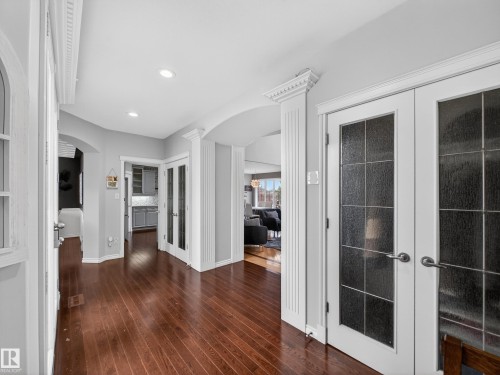 Hallway with rich wood-finish flooring and recessed lighting - 1062 Tory Road, Edmonton, AB - Indoor Photo Showing Other Room