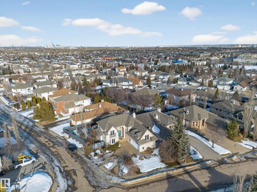 Residential property featuring a light-colored exterior with a prominent front entrance, an attached garage, and a gabled roofline - 1062 Tory Road, Edmonton, AB - Outdoor With View
