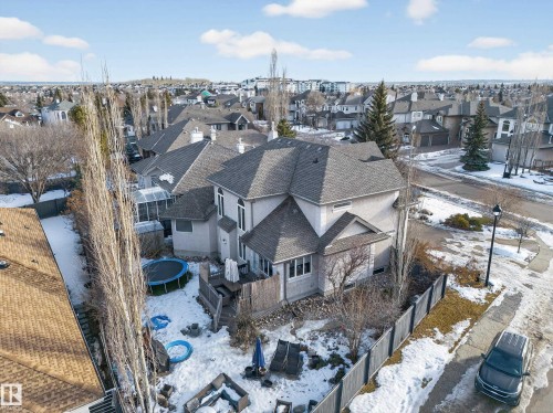 Rear exterior of a multi-story residence featuring a private fenced yard and an elevated wood deck - 1062 Tory Road, Edmonton, AB - Outdoor With View