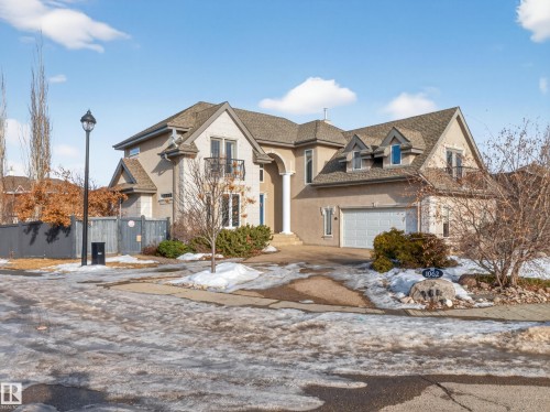 Stucco exterior residence with a double-car garage and a stone-detailed entryway - 1062 Tory Road, Edmonton, AB - Outdoor With Facade