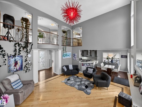 Two-story living area featuring a vaulted ceiling and an ornate red light fixture - 1062 Tory Road, Edmonton, AB - Indoor