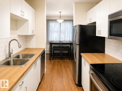 Photo has been digitally enhanced. - 10 11108 108 Avenue, Edmonton, AB - Indoor Photo Showing Kitchen With Double Sink