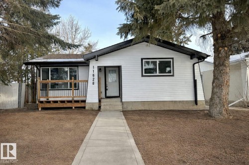 Single-story residence featuring white horizontal siding and black trim accents - 11628 151 Avenue, Edmonton, AB - Outdoor