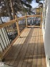 Wood-finish deck with natural wood railing and black metal balusters - 11628 151 Avenue, Edmonton, AB  - Outdoor With Deck Patio Veranda 