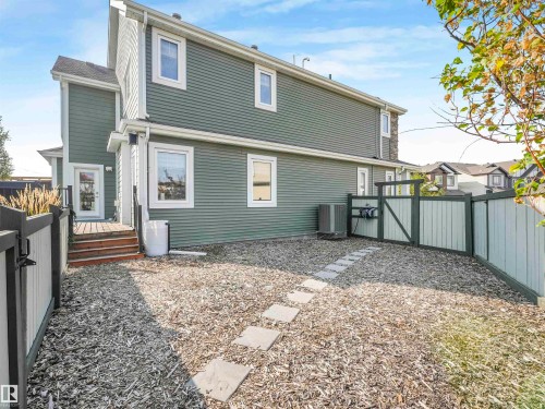 Thoughtful design has been poured into every inch of this massive yard, including the dedicated dog run or versatile flex space. - 17703 9A Avenue, Edmonton, AB - Outdoor With Deck Patio Veranda With Exterior