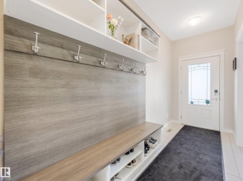 Thoughtfully designed entrance foyer with built-in seating, generous coat hooks, and smart shoe storage. - 17703 9A Avenue, Edmonton, AB - Indoor Photo Showing Other Room