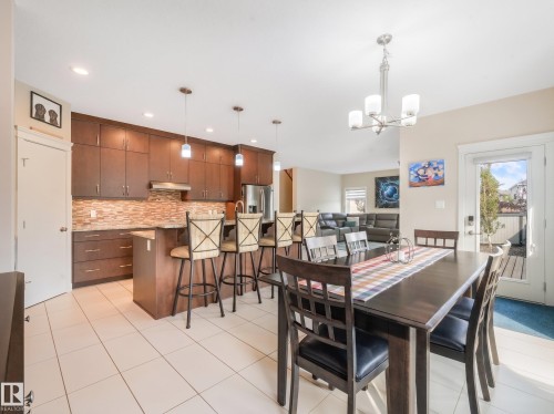 Spacious dining area with sweeping views of the expansive backyard and seamless access to your immaculate outdoor space. - 17703 9A Avenue, Edmonton, AB - Indoor Photo Showing Dining Room