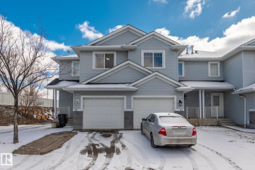 Light blue siding exterior with white trim - 92 4350 23 Street, Edmonton, AB - Outdoor With Facade