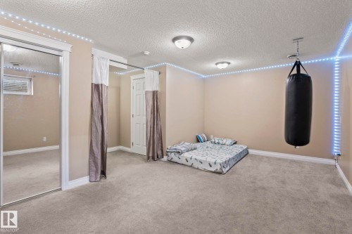 Carpeted room featuring neutral wall paint, white baseboards, and ceiling-mounted light fixtures - 92 4350 23 Street, Edmonton, AB - Indoor