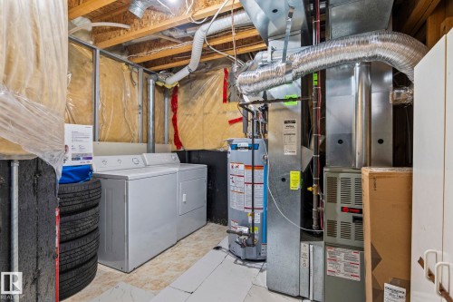 Utility area featuring a washer and dryer, water heater, and HVAC system - 92 4350 23 Street, Edmonton, AB - Indoor Photo Showing Other Room