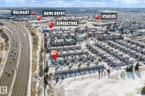 Aerial view showcasing a residential community with multi-story townhomes and apartment buildings - 92 4350 23 Street, Edmonton, AB - Outdoor With View
