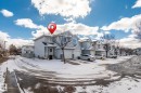 Two-story residence featuring light blue siding, a covered entry, and an attached single-car garage - 92 4350 23 Street, Edmonton, AB  - Outdoor 