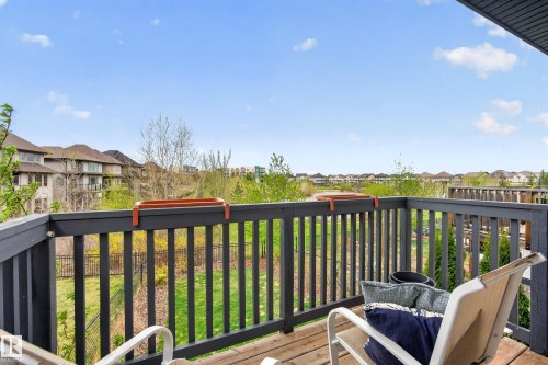 Wood-finish flooring balcony with a dark wood railing, offering expansive outdoor space - 2146 Austin Link Link, Edmonton, AB - Outdoor With Balcony With Deck Patio Veranda With Exterior