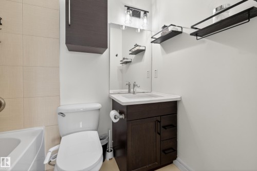 Bathroom featuring a dark wood-finish vanity with an integrated sink and white countertop - 2146 Austin Link Link, Edmonton, AB - Indoor Photo Showing Bathroom