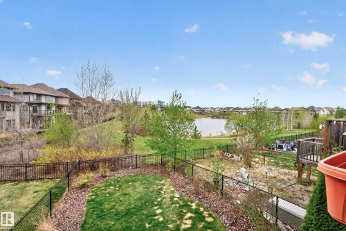Expansive property featuring a fenced backyard, mature trees, and a distant lake - 2146 Austin Link Link, Edmonton, AB - Outdoor