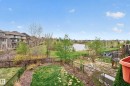 Expansive property featuring a fenced backyard, mature trees, and a distant lake - 2146 Austin Link Link, Edmonton, AB  - Outdoor 
