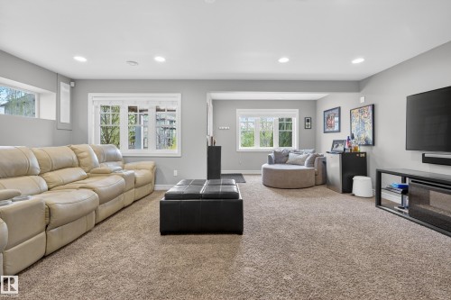 Spacious carpeted room featuring recessed lighting and multiple windows - 2146 Austin Link Link, Edmonton, AB - Indoor Photo Showing Living Room