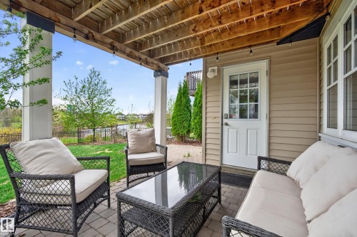 Covered patio area featuring a paver stone floor and a direct exterior door with window panes - 2146 Austin Link Link, Edmonton, AB - Outdoor With Deck Patio Veranda With Exterior