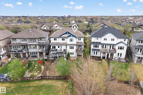 Multi-level property featuring multiple balconies, a lower-level patio, and a tiered backyard - 2146 Austin Link Link, Edmonton, AB - Outdoor With Balcony