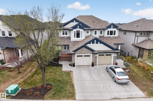 Two-story residence featuring a multi-gable roofline, dormer windows, and a combination of siding and stone facade - 2146 Austin Link Link, Edmonton, AB - Outdoor With Facade