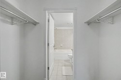 Walk-in closet featuring dual shelving and hanging rods - 