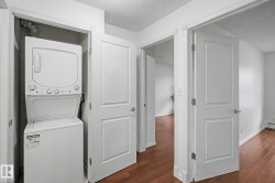 Dedicated laundry closet featuring a stacked washer and dryer unit - 