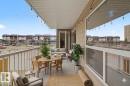 Private balcony featuring a concrete floor, light tan siding, and string lighting - 213 17404 64 Avenue, Edmonton, AB 