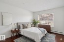 Hardwood flooring complements white walls and ceiling - 213 17404 64 Avenue, Edmonton, AB 