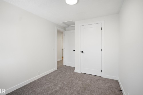 Room with textured gray carpeting, white painted walls, and white trim - 1706 37 Street, Edmonton, AB - Indoor Photo Showing Other Room