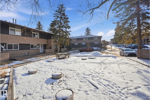 Two-story residential building with two-tone siding, multiple windows, and individual entrances - 1706 37 Street, Edmonton, AB - Outdoor