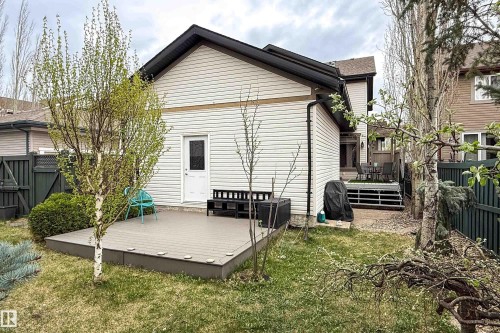 Rear exterior featuring durable siding, a ground-level composite deck, and a multi-tier deck with steps - 2016 125 Street, Edmonton, AB - Outdoor With Deck Patio Veranda