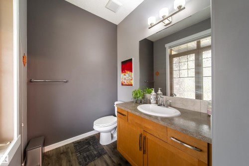 Vanity featuring wood cabinetry, a single basin sink, and a gray countertop - 2016 125 Street, Edmonton, AB - Indoor Photo Showing Bathroom